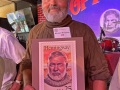 Michael Kimbahh holds an enlarged facsimile of an Ernest Hemingway U.S. postage stamp to demonstrate his appearance at the Hemingway Look-Alike Contest Thursday, July 22, 2021, at Sloppy Joe’s Bar in Key West, Fla. The 2020 contest, part of the subtropical island’s Hemingway Days festival, was canceled last year due to COVID-19. Thursday night’s competition attracted 72 entrants and a second preliminary round is set for Friday, July 23, with the finals scheduled for Saturday, July 24. Ernest Hemingway lived in Key West throughout most of the 1930s. FOR EDITORIAL USE ONLY (Andy Newman/Florida Keys News Bureau/HO)