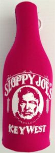 Magenta neoprene bottle coolie with hard bottom, sloppy joe's key west logo