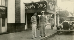 Two men in front of sloppy joe's bar